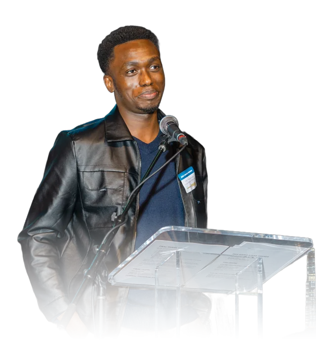 Fiston Ndayishimiye smiling at the podium at the Stay Work Play Rising Stars Awards.